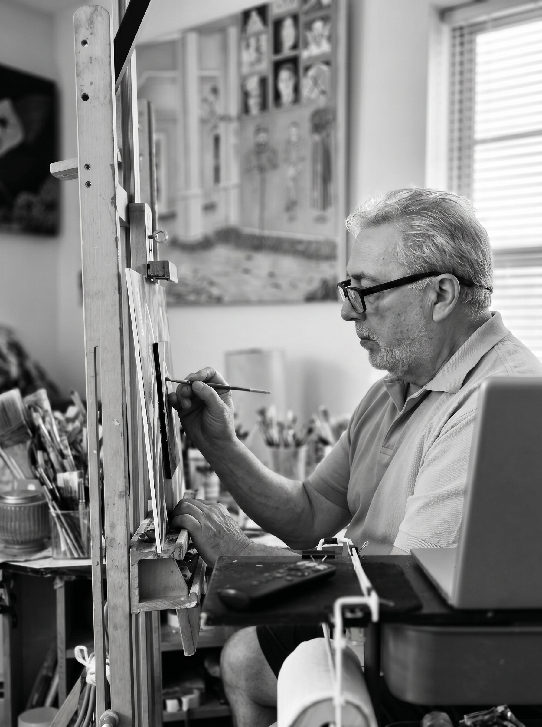 Edgar Leal painting in a black and white studio photo